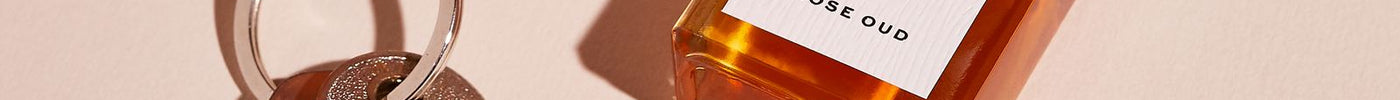Rose Oud perfume oil beside a set of old keys